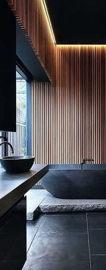Elegant bathroom with freestanding tub and ambient lighting.