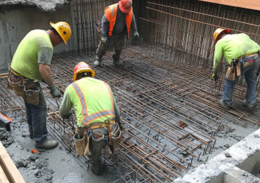 Construction workers strengthening building foundations with advanced repair techniques.